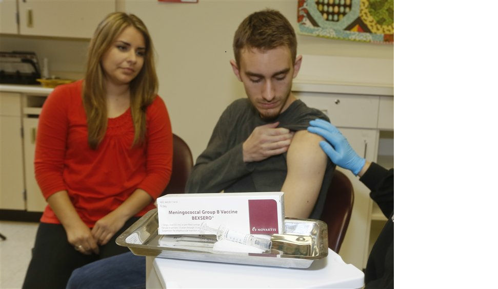 Meningococcal meningitis survivor and vaccination advocate Leslie Meigs looks on as her brother Andrew (18), a college student in Texas, receives Bexsero®, a meningococcal group B vaccine approved by the FDA for ages 10-25 in January. Meningococcal group B is one of the most prevalent types of meningococcal disease in the US, and adolescents and young adults are at risk due to common lifestyle habits such as living in college dormitories. Bexsero is approved to help protect against the potentially deadly disease in two doses, however is not expected to cover all group B strains. 