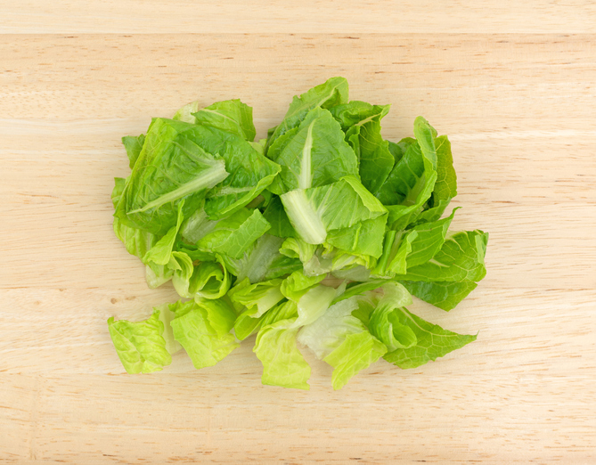 Top view of romaine lettuce that has been sliced on a wood cutting board. /CDC